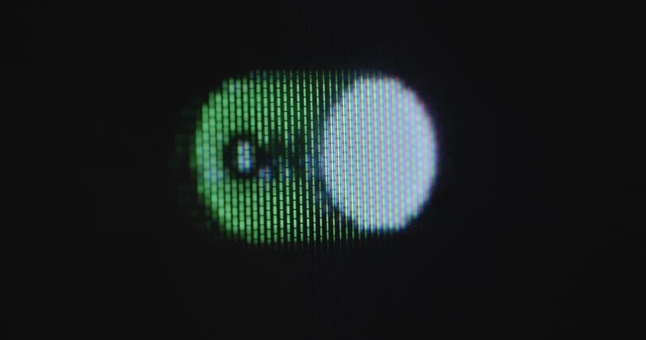 Unrecognisable person uses index finger to activate or deactivate a button or switch on a touch screen display device like a smartphone or computer to turn an application or function on and off