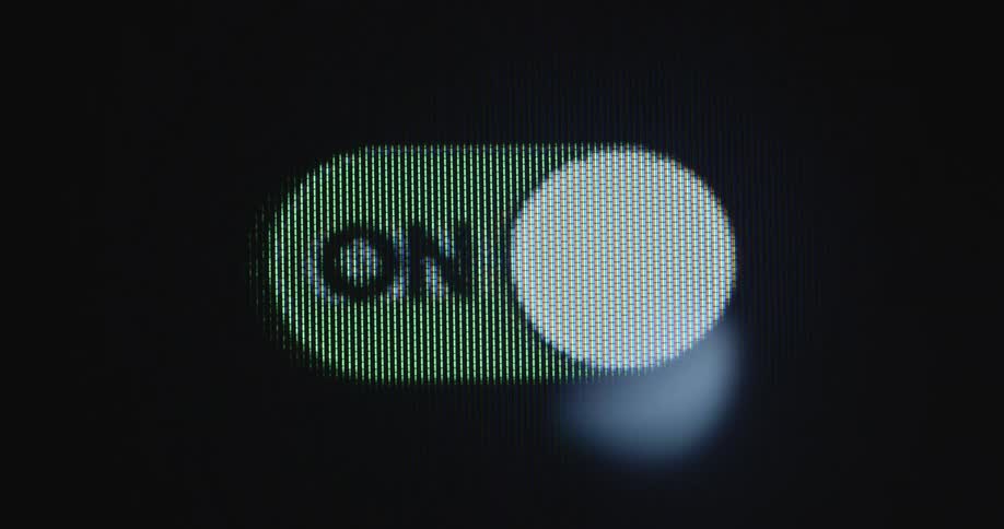 Close up of a digital sliding on and off button switching from green to red while activating or deactivating an application or program on a computer or smartphone device with a pixelated screen