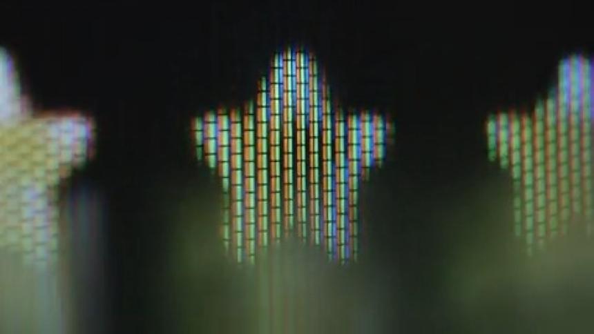 Extreme macro closeup of a retro RGB TV screen displaying three yellow stars from a positive review from a happy and satisfied customer of an online store or booking portal