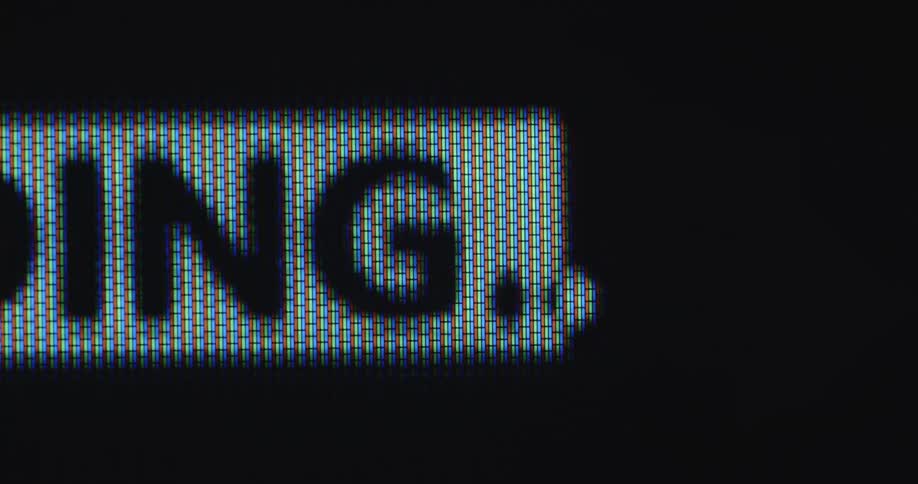 Close up of a black and white retro loading bar animation filling on a digital computer screen as a symbol for progress or waiting time with dynamic panning camera movement