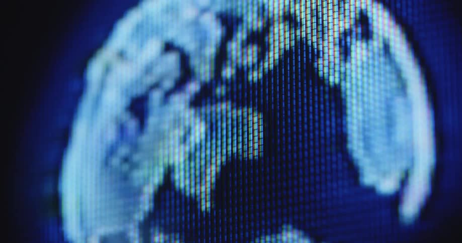 A futuristic hologram of the earth as a digital world or globe is spinning on the display of a retro or vintage tube TV showing all the countries and continents from an out of space perspective