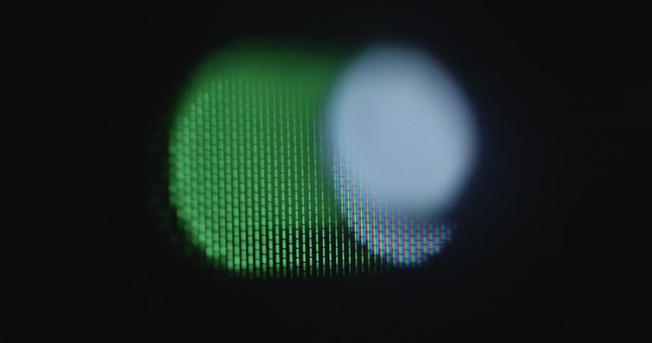 Extreme macro closeup of a dark retro computer screen with a power symbol switching on and off as a symbol for a beginning start or ending of a program or process