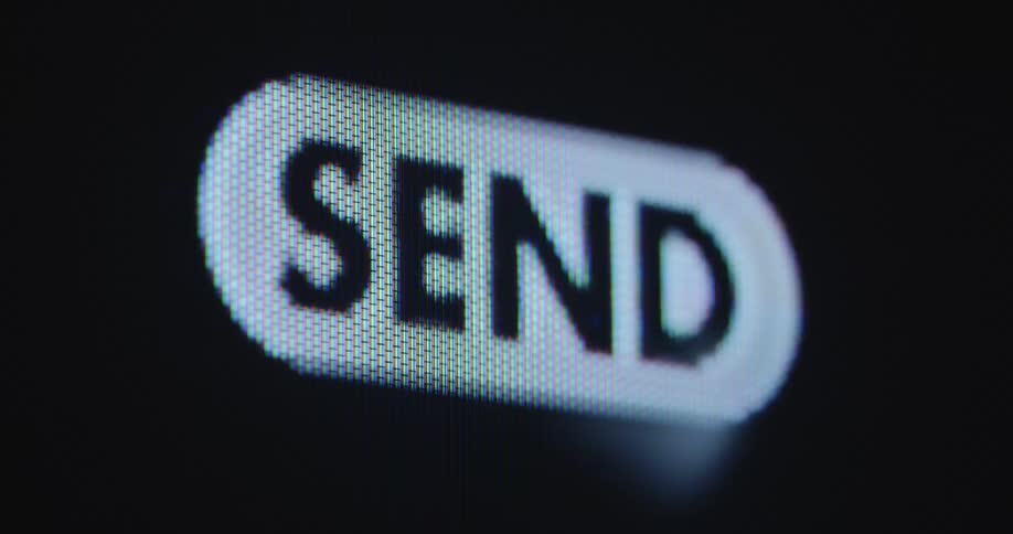 Close up of a mouse cursor clicking on a send button on computer screen to send a digital letter or message or email by using an online service or communication application