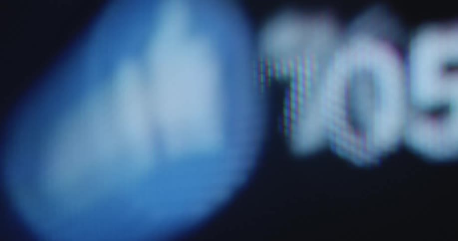 Extreme macro close up of pixelated television or computer screen as the numbers of likes counts up by the thumbs-up symbol due to increasing or rising social media engagement
