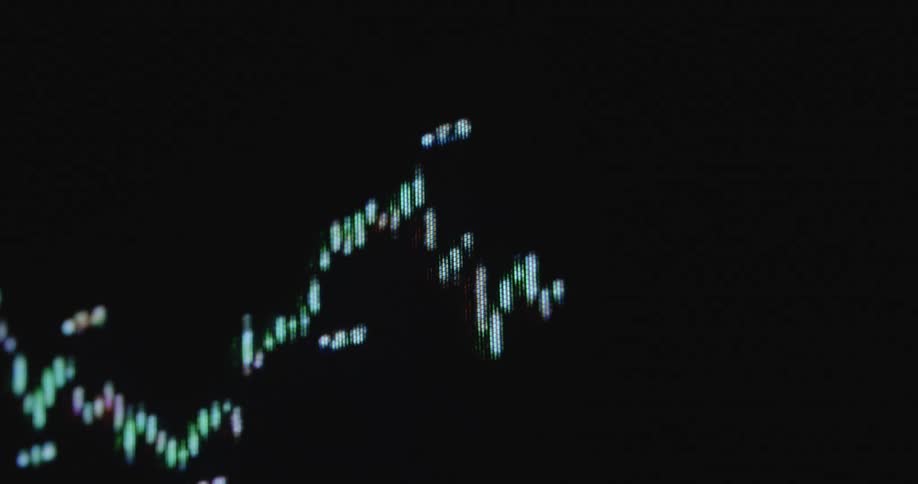 Futuristic closeup of a computer screen displaying a stock market graph or candle chart with ups and downs and upward tendency representing the digital and modern finance sector