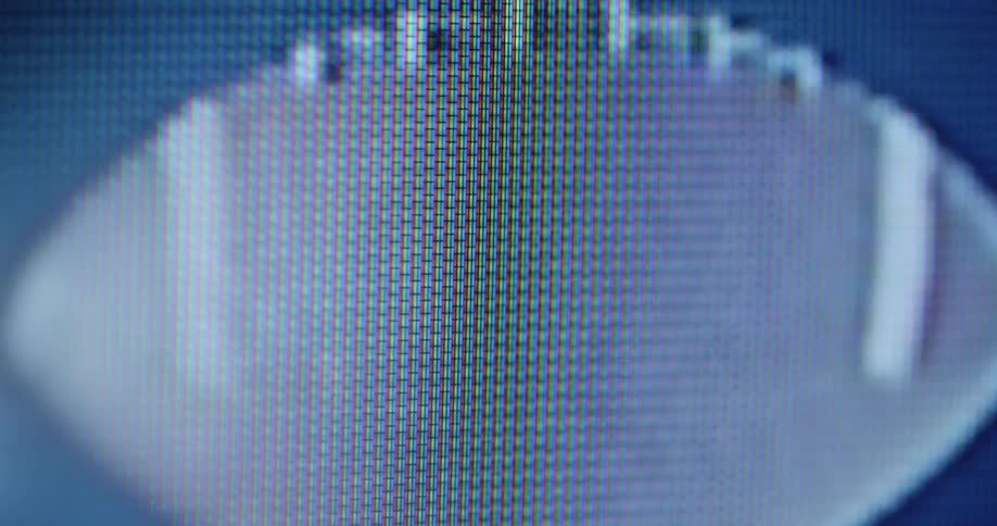 Dynamic handheld footage of rotating brown and white American football flying and spinning in the air promoting the Super Bowl or other sports events on pixelated TV screen
