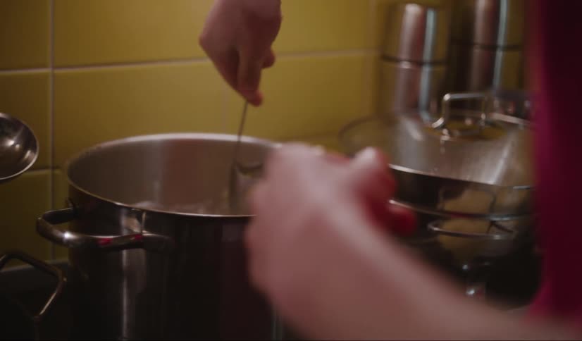 A person is cooking pasta in the pot