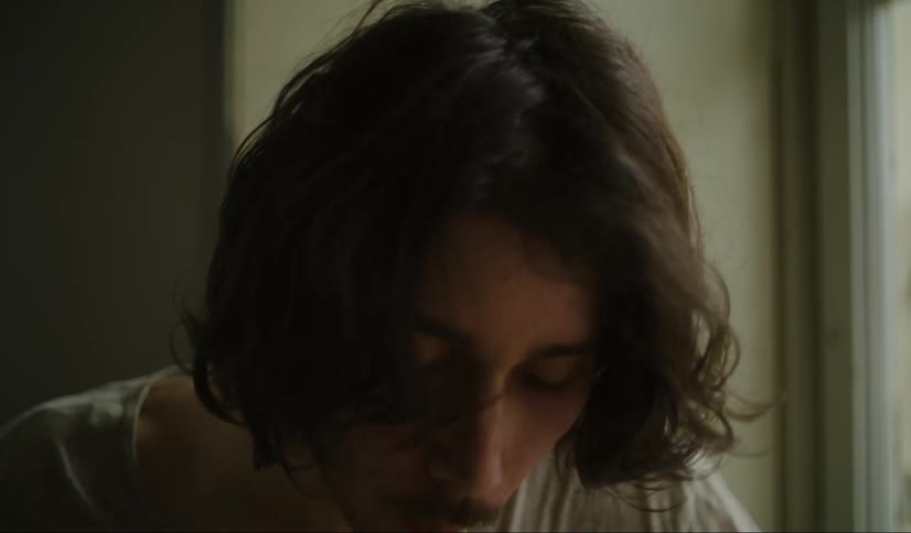Close up of a young man eating spaghetti at home