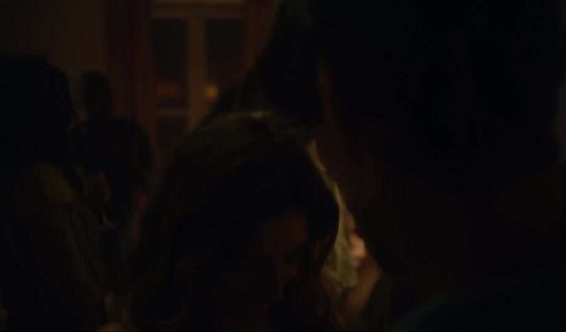 Couple dances together at dance party with other friends