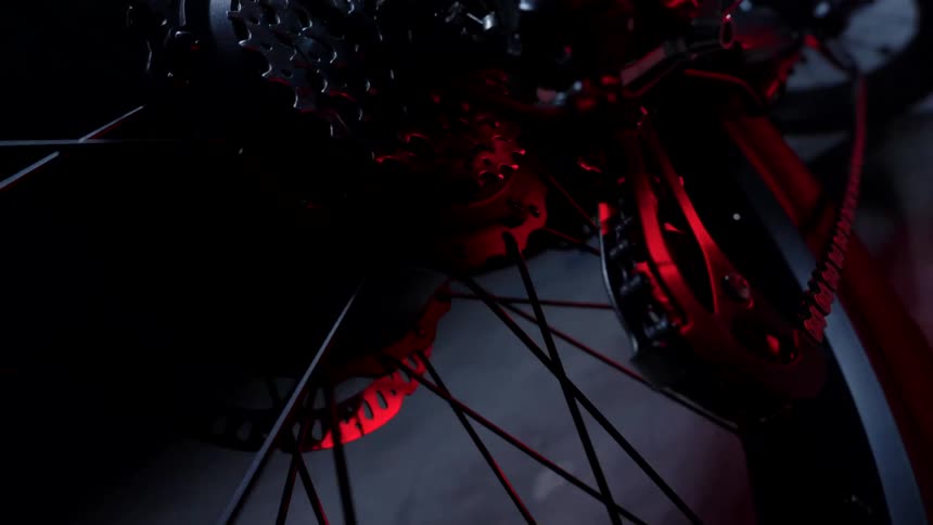 A closeup view capturing the bicycles speed cassette and tire