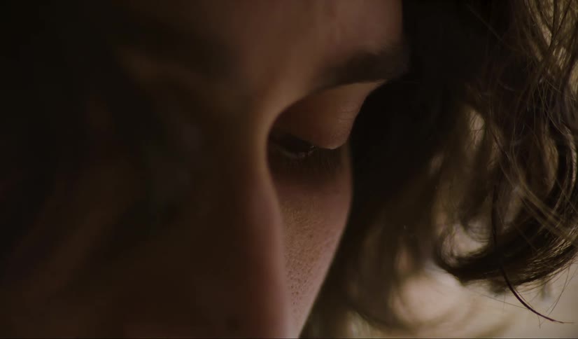 Close up of man with long hair looking down