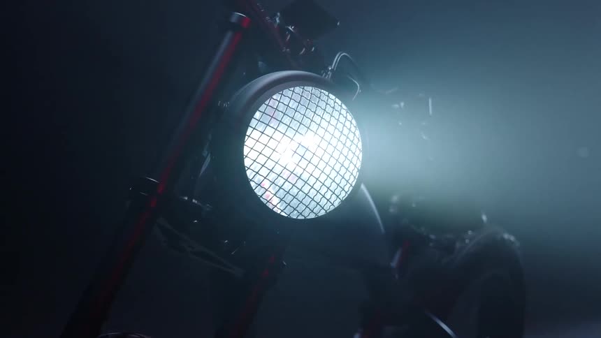 The bicycle headlight is on casting a steady beam in the darkness