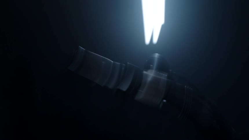 View of the headlight of a motorcycle turned on inside a dark room
