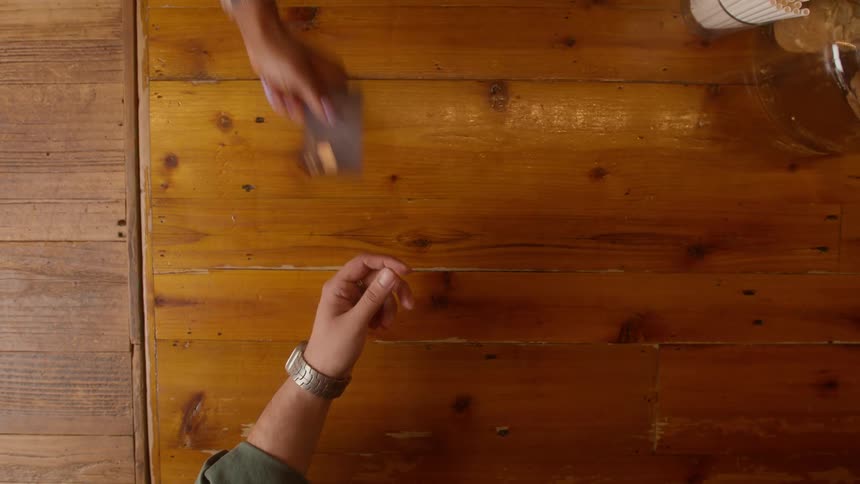 A person hands a credit card to someone