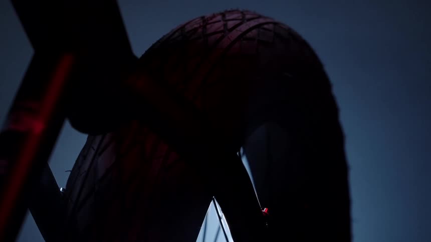 Light flares behind a bicycle wheel