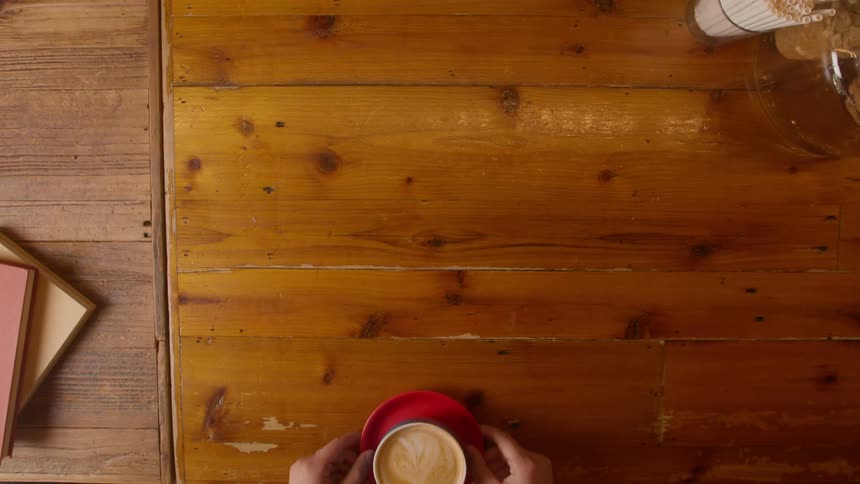 A man serving coffee and cookie to another person