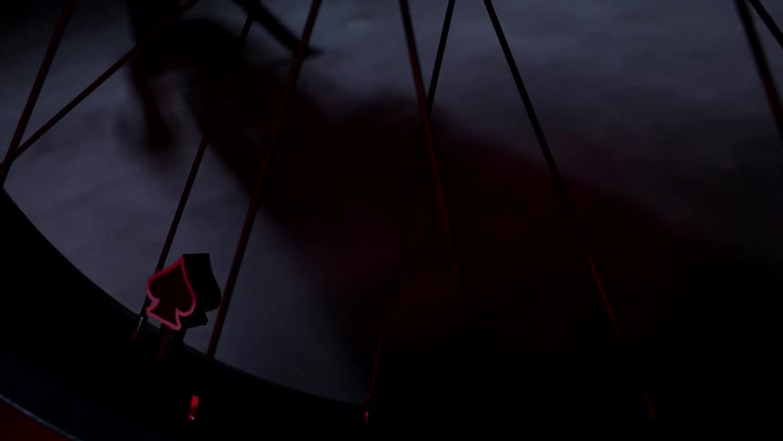 The bike wheel is in a dark room