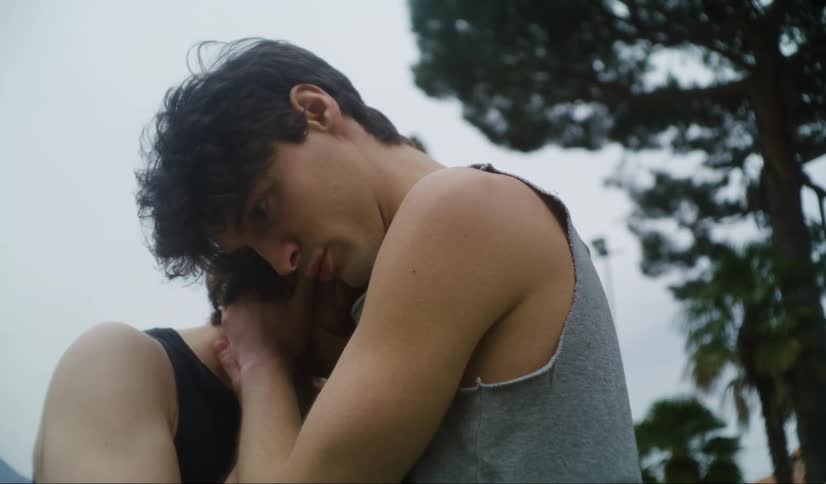 Man consoles his girlfriend with a hug outside