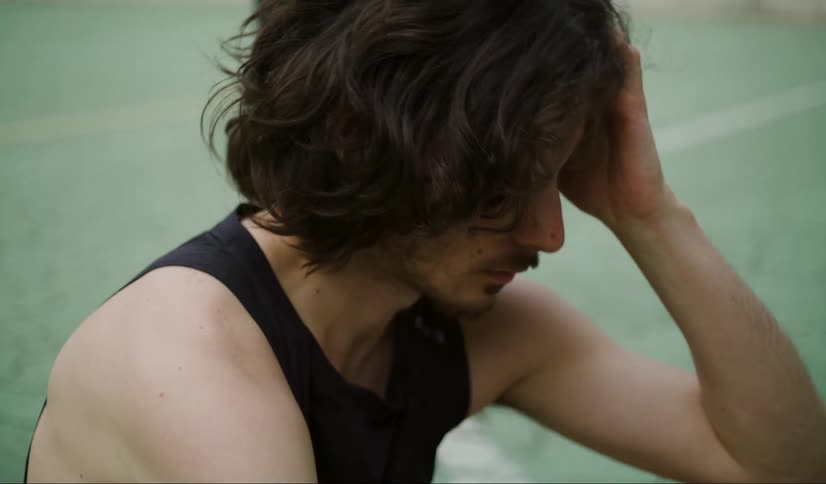 A close up clip of a male rubbing his head