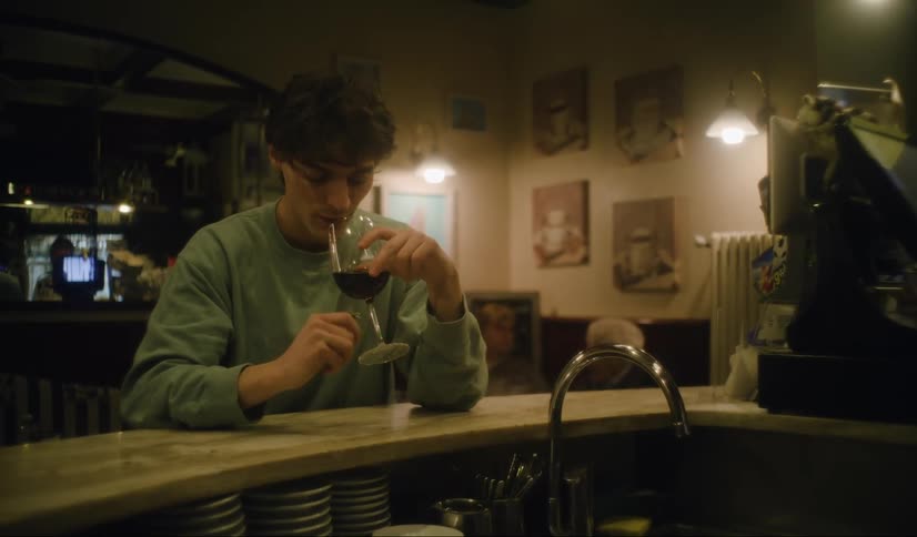 Man drinking wine alone in a bar