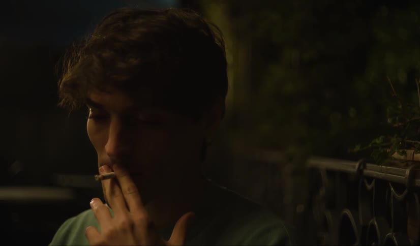 A man is smoking at night