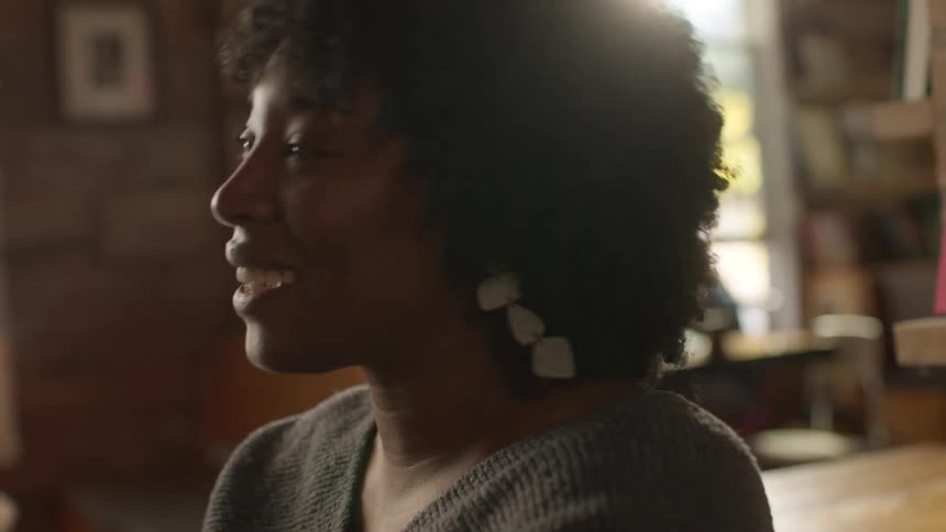 Happy woman laughs while talking to a friend