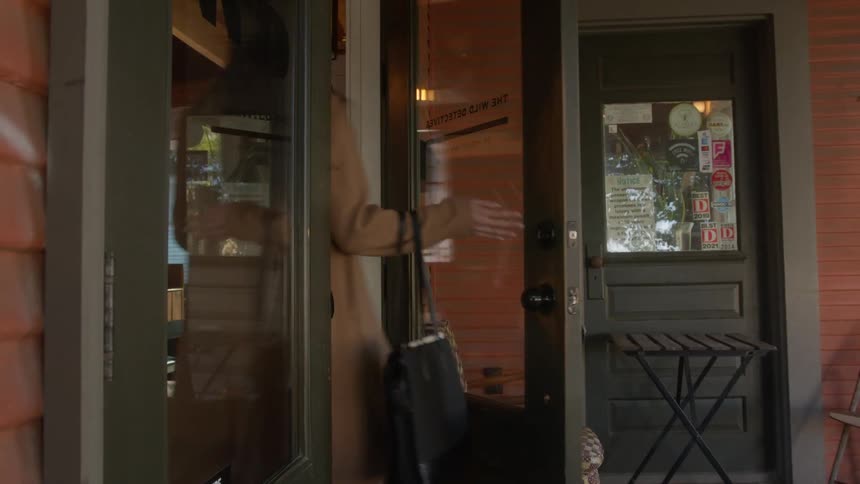 Woman entering through the door of an establishment