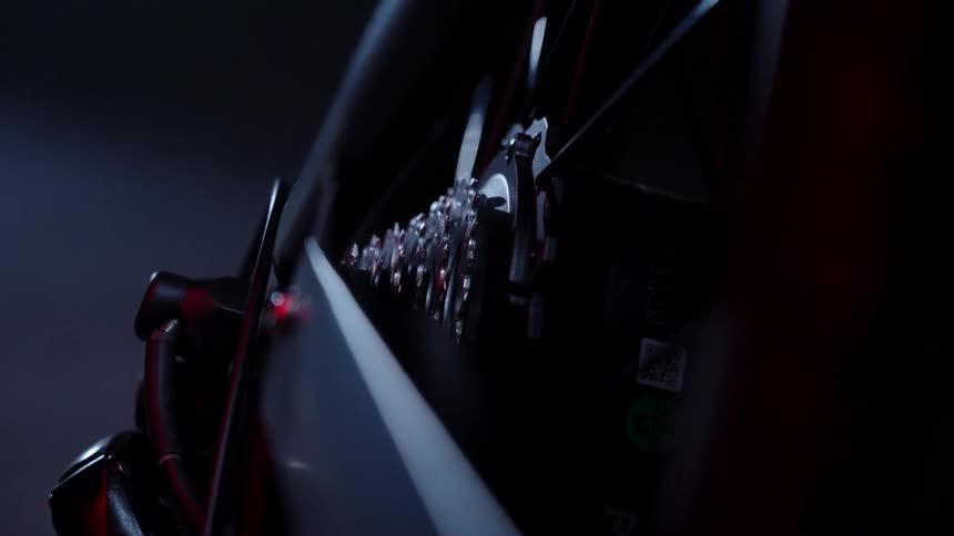 Six gears on a black bicycle in a dark gray space