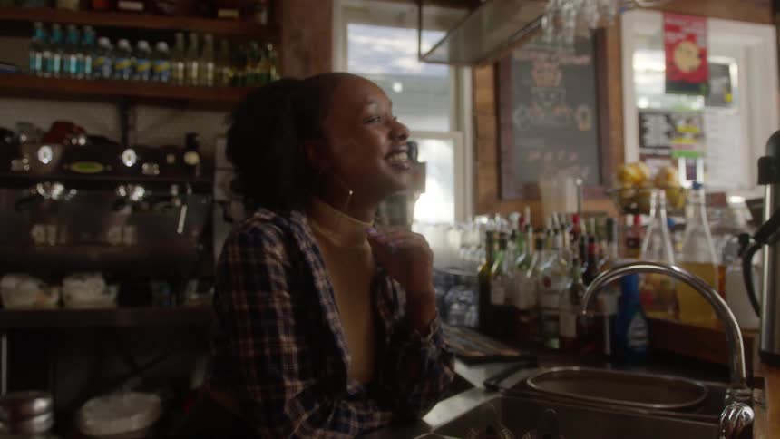 Coffee shop employee talks to a customer