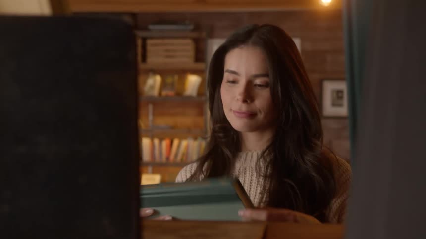 Woman picks up a book in a bookstore