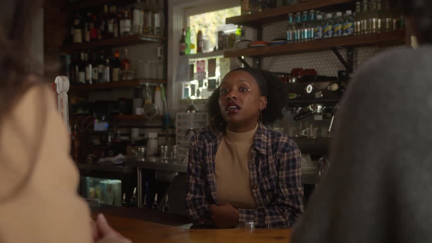 Women chatting at the bar under the daylight