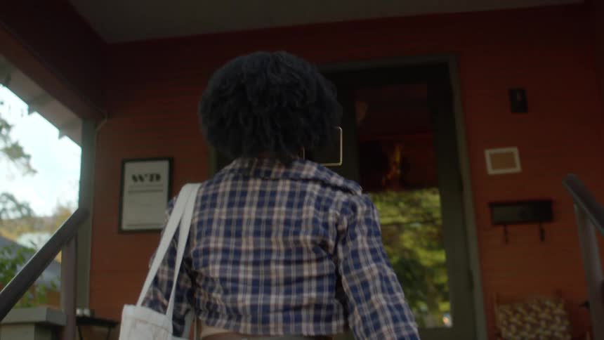 Woman walks to a coffee shop in the neighborhood
