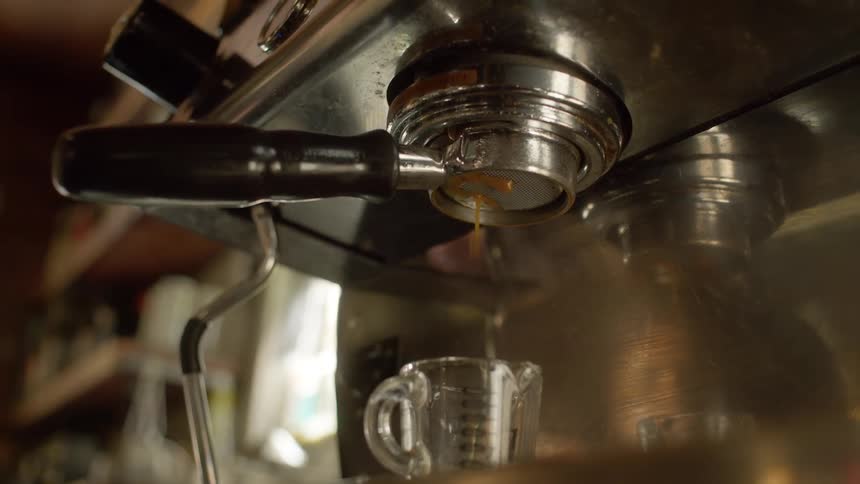 The coffee machine is running in the coffee shop