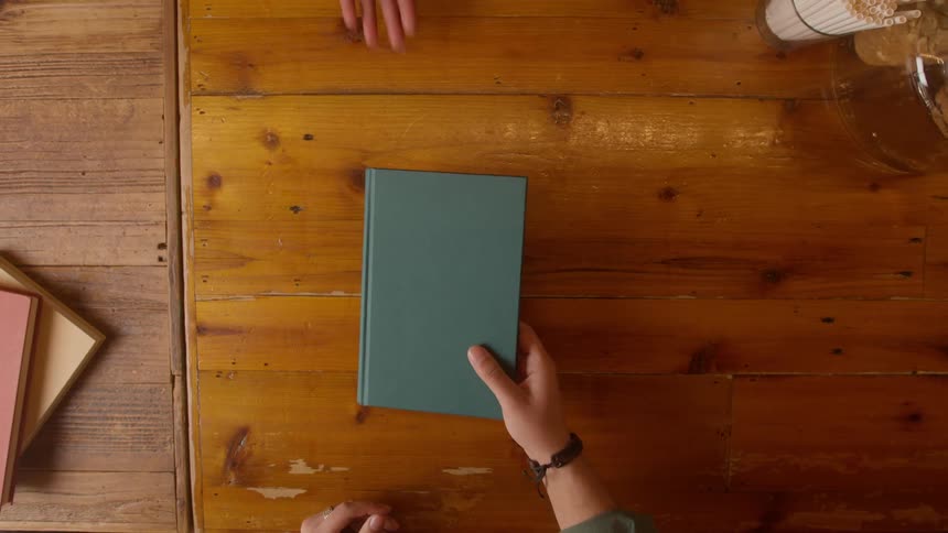 A person passes a book to someone