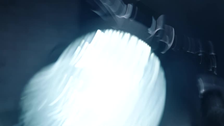 Shaky close up of the headlight of a motorcycle
