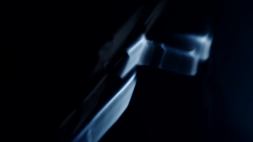 Shaky footage of a motorcycle on a dimly lit room