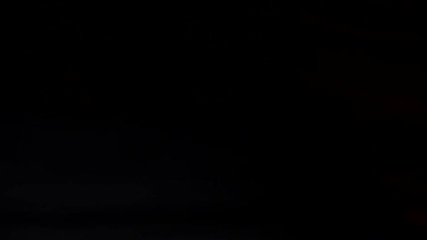 A motorcycle is in the dark garage