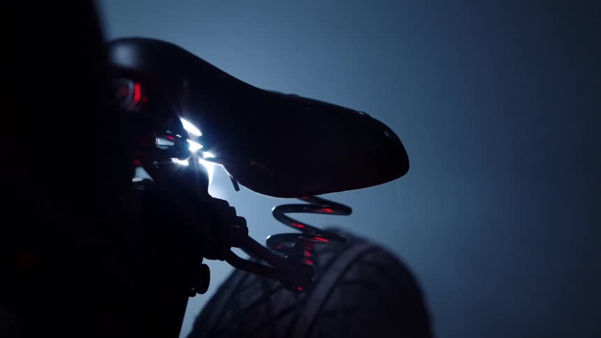 Closeup of the seat of a twowheeled vehicle in a dimly lit indoor space