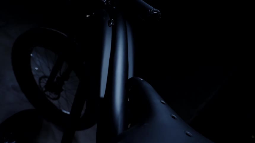 The black bike is parked in the garage