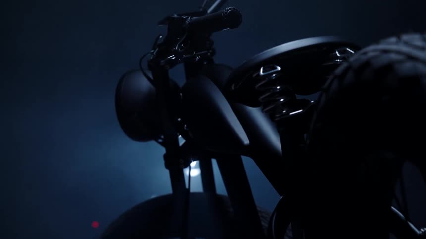 A bike is parked in the dark garage