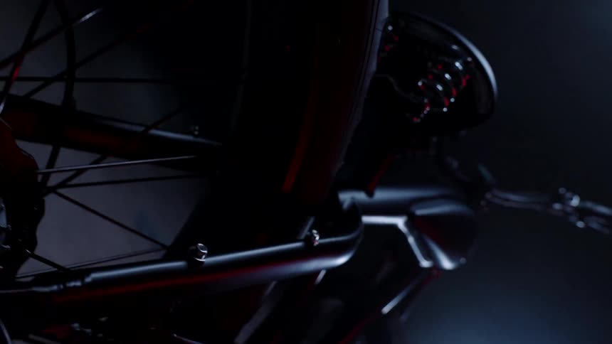 Bright light shines onto motorcycle parked on concrete
