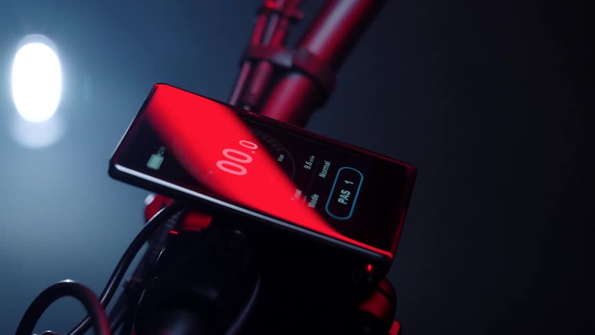 A tablet is on the steering bar of the motorcycle