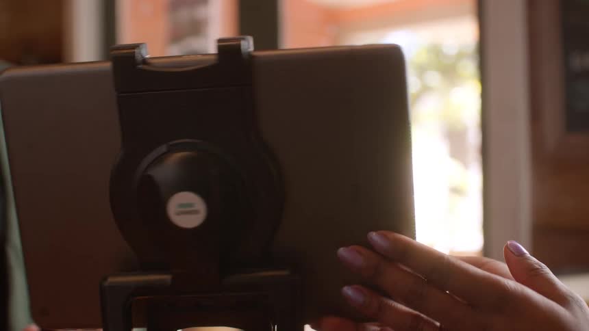 Employee on a coffee shop process a customer payment