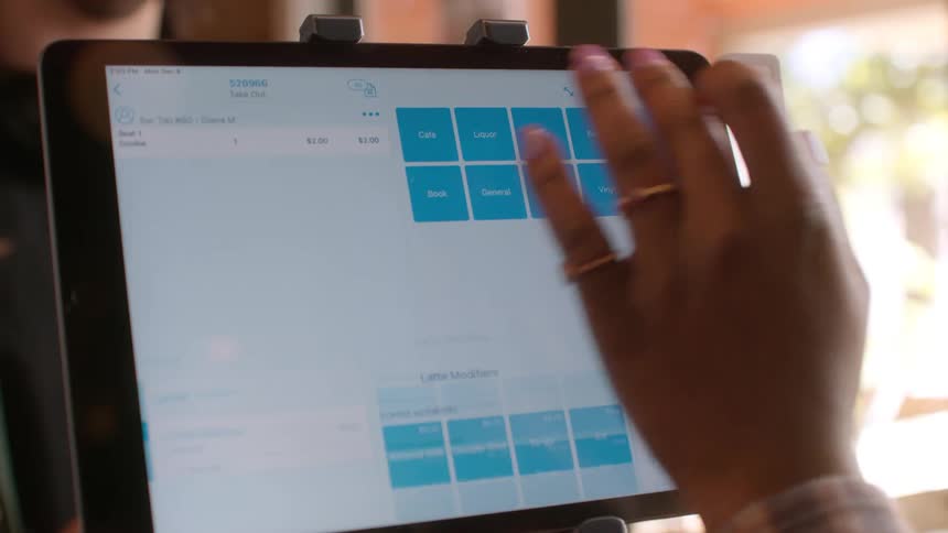 Employee on a coffee shop process a customer payment