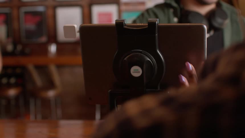 Employee on a coffee shop process a customer payment