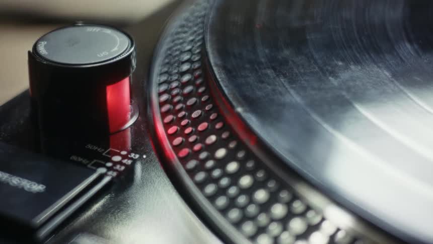 Person adjusts dial and starts turntable by pushing a button