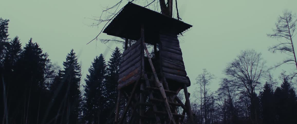 A clip of a wooden watch house in the woods