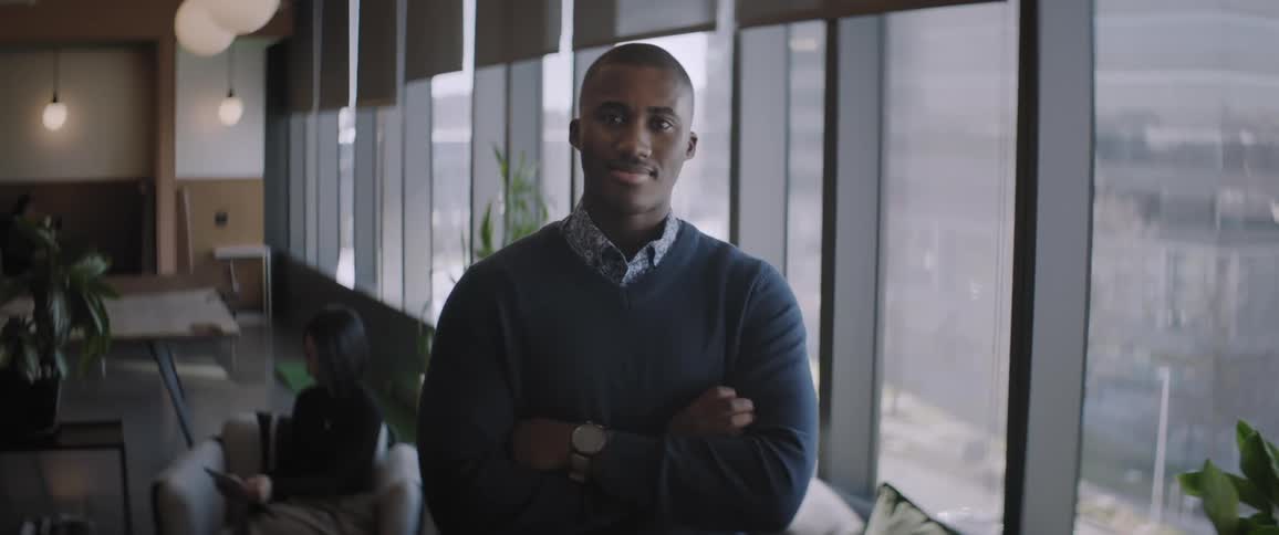 A young man in a stylish office during the day