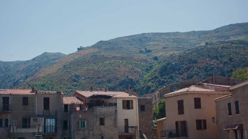 Several multistory residential buildings are located at the base of a mountain