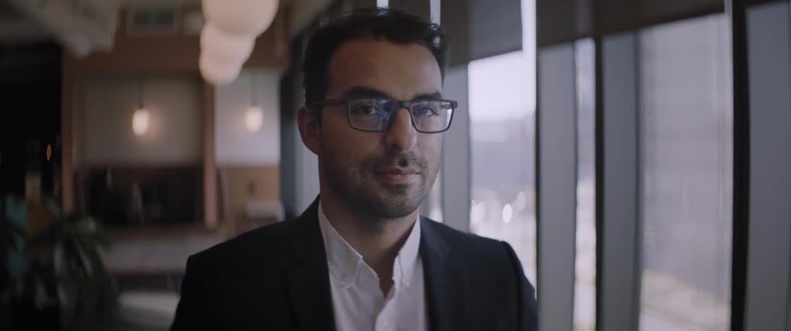 Businessman in the office looks at the camera